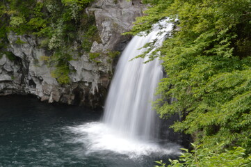 Obraz premium Exploring the waterfalls and coastal landscapes of the Jeju Island in South Korea