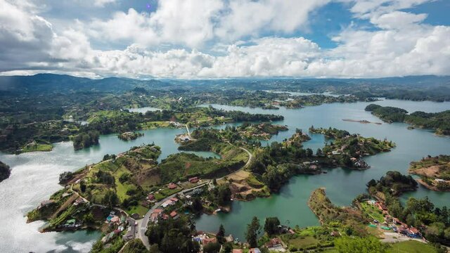 Zoom out time lapse view of dramatic skies over the Guatape Reservoir near Medellin, Antioquia Department, Colombia.