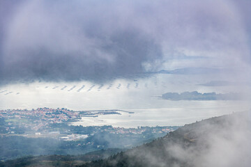 Aerial view of Rianxo on the Ria de Arousa estuary from the Muralla mountain on a foggy Summer afternoon.