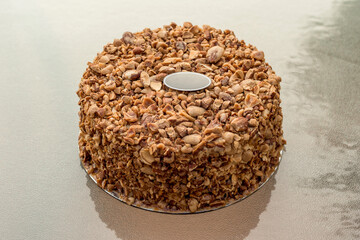 Beatiful nut biscuit cake finished with crushed sugar-coated candied caramelized almonds