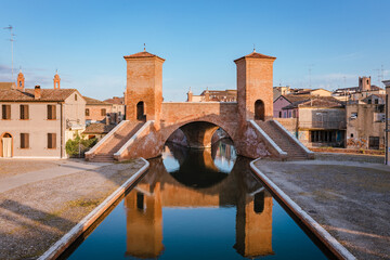 Comacchio, Ferrara / Italy - August 2020: Trepponti Bridge in Comacchio, blue sky with clouds