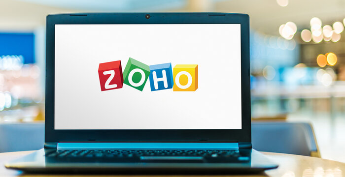 Laptop computer displaying logo of Zoho
