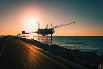 Marina di Ravenna, Ravenna / Italy - August 2020: Molo Zaccagnini during the sunrise