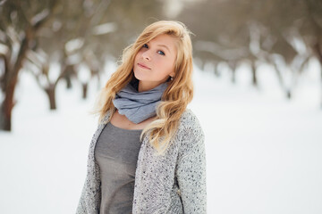 Portrait of young blonde woman on a sunny day in winter