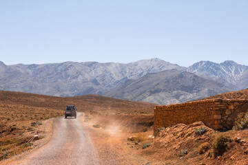 Off road 4x4 vehicle in dry mountainous desert area 