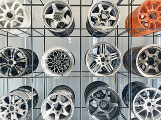 wall of alloy wheels in the store. Auto repair shop background. Auto Wheel Service