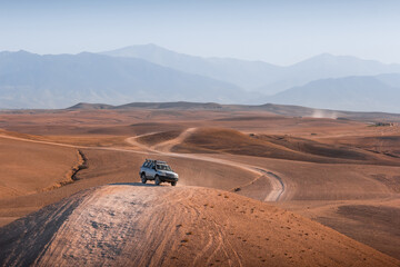 Off road 4x4 vehicle in dry mountainous desert area  © Liam M