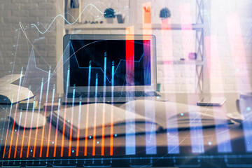 Financial chart drawing and table with computer on background. Double exposure. Concept of...