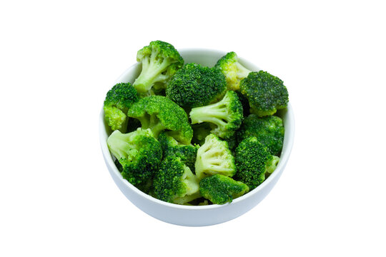 Frozen broccoli florets in a bowl isolated on white background, top view