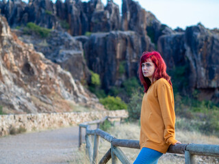 Fototapeta na wymiar Closeup shot of a beautiful young lady with red hair in Cerro del Hierro, Sevilla, Spain