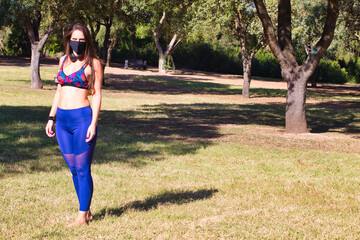 young woman with black preparing to do session yoga