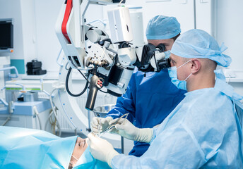 Naklejka na ściany i meble A team of surgeons performing brain surgery to remove a tumor.