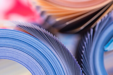 Colorful magazine with pages rolled macro