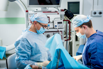 Surgeons in the operating room trying to save the patient's hand.