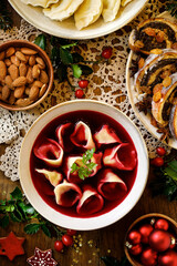 Christmas beetroot borscht in ceramic bowl on the holiday table, top view.  Traditional Christmas Eve soup in Poland