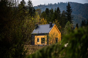 Yellow lonely house in the mountains for cozy leisure