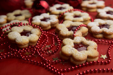 Christmas cookies and decorations on a red background.