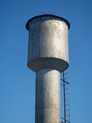 Old metal water tower In Sunny Day In Countryside In Russia In Summer.
