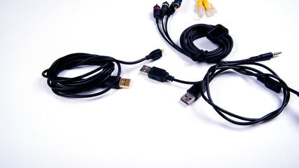 Different cables for connecting different connectors for connecting electronic boards, audio and video inputs, isolated, copy space, on a white background,