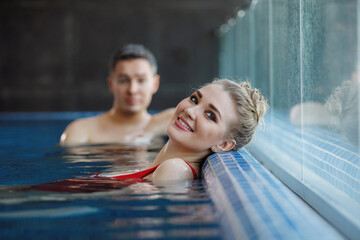 Man and woman leisure in the pool.