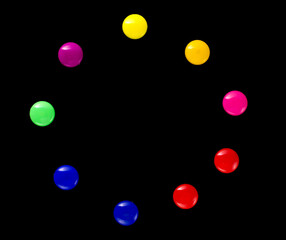 background frame of colored magnetic paper clips in the form of a circle on a black background