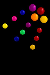 background frame made of colored magnetic paper clips on black background with space for text