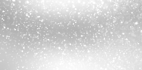 Snow fluffy flakes falling on silver background. White grey blurred pattern. Winter texture.