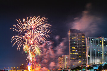 Firework display for celebration happy new year and merry christmas with Twilight night and firework lighting in bangkok cityscape, Thailand.