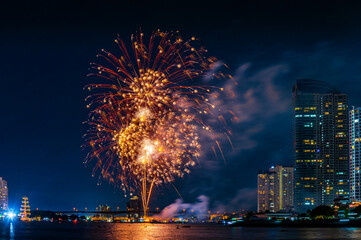 Firework display for celebration happy new year and merry christmas with Twilight night and firework lighting in bangkok cityscape, Thailand.