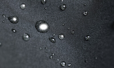 Waterproof fabric, clothing with waterdrops. Rain drops on water resistant textile waterproof...