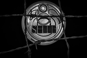 SHTF text on top of canned food with barbed wire in monochrome