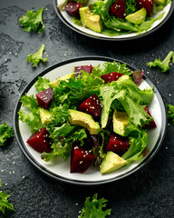 Vegetarian avocado and beet salad in plate. Healthy vegan food