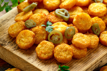 Mini hash browns, tater tots crispy golden potato bites served with jalapeno peppers dipped in ketchup