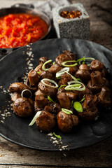 Fried marinated mushrooms with onions and garlic on a plate