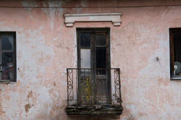 Fototapeta na wymiar Old balcony in the old weathered house. 