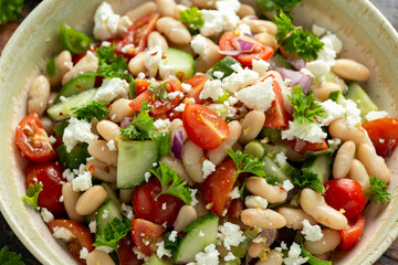 White Bean Salad with Cherry Tomatoes, Cucumber, Red onion, Feta cheese and parsley. Healthy vegetarian, vegan diet food