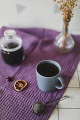 Morning tea with homemade oatmeal cookies on kitchen table with purple linen towel. Breakfast scene in the kitchen. copy space