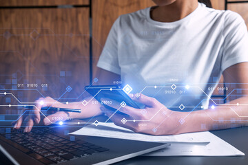 Businesswoman typing on laptop in office. Technology network illustration hologram.