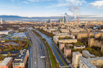 cityscape at sunrise on autumn morning with old houses, highways and river shot from drone