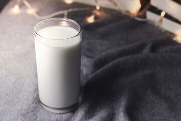 A glass of milk on table with bokeh background