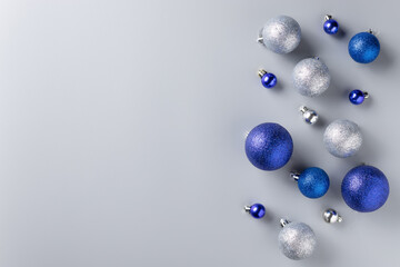 Christmas flat lay background with silver and blue decorations on gray background. Christmas,...