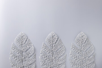 Christmas flat lay background with frosty decorative leaves on gray background. Christmas greeting card. Xmas mock up. place for your text or design