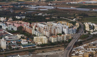 Obraz premium Aerial view of the city of Faro the beautiful Algarve coast in Portugal seen on a flight to Faro