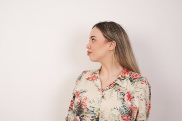 Profile of serious woman isolated over grey studio wall with healthy pure skin has contemplative expression ready to have outdoor walk