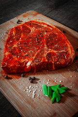 Raw marinated meat Steak for bbq, pork chop on a Wooden Chopping Board