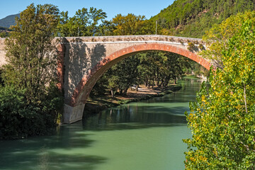 Arch bridge over the Metauro river in Fossombrone, Italy.