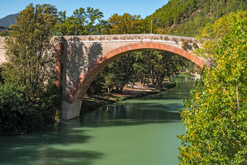 Fototapeta na wymiar Arch bridge over the Metauro river in Fossombrone, Italy.