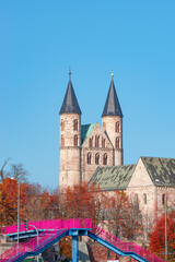 Ancient two towers of Church Monastery of Our Beloved Women (Kloster Unser Lieben Frauen) in historical downtown of Magdeburg at blue sky in golden Autumn colors, Magdeburg, Germany, details.