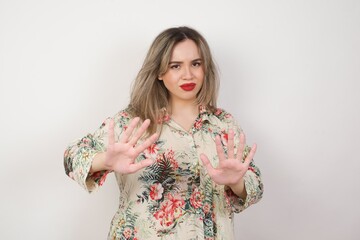 Beautiful brunette girl over isolated background afraid and terrified with fear, and disgusted expression stop gesture with both hands saying: Stay there. Panic concept.