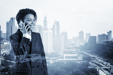 Successful smiling black African American business woman in suit pensively talking phone, Kuala Lumpur cityscape. The concept of consultants as problem solvers. KL skyscrapers. Double exposure.